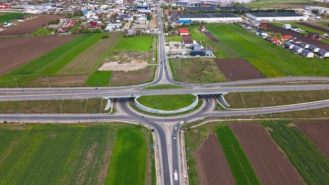 Aerial hyperlapse of major roundabout and overpass at Suceava entrance showing traffic flow and road infrastructure in Romania