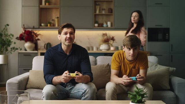 Mom taking gamepads away from her husband and teen son, parental control concept