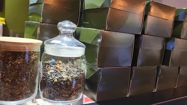 Decorative glass jars with tea and aromatic ingredients, domestic wellness and healthy food lifestyle cake storage box