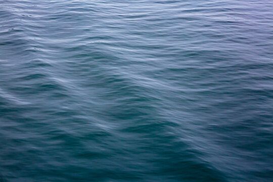 Motion blurred ocean waves, ripples in the surface.