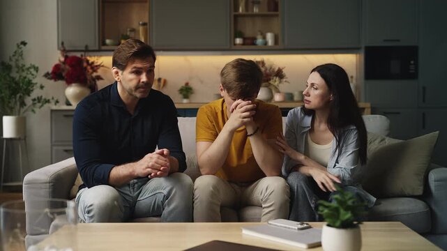 Mom and dad comforting and supporting their upset adolescent son, parental care