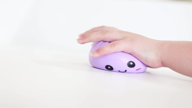 Child hand squeezing purple smiling dumpling squishy