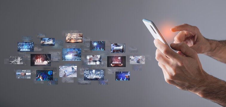 Man holding smartphone with a digital pictures of business graphs.
