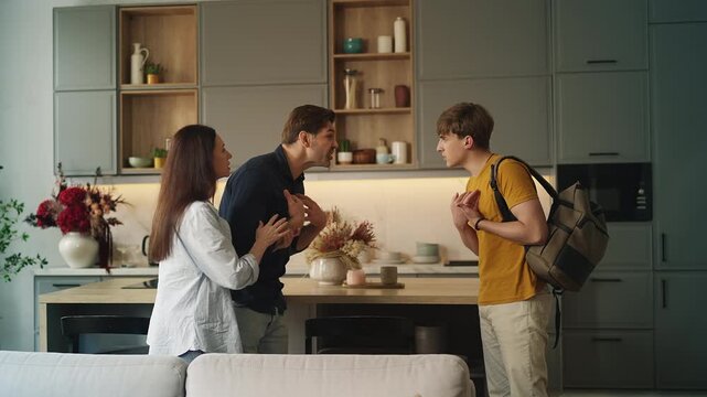 Adolescent boy arguing with displeased parents at home, family conflict