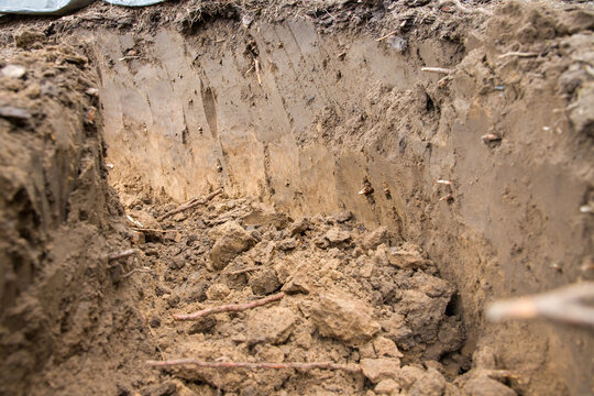 Dirty soil in the garden after digging a hole in the ground