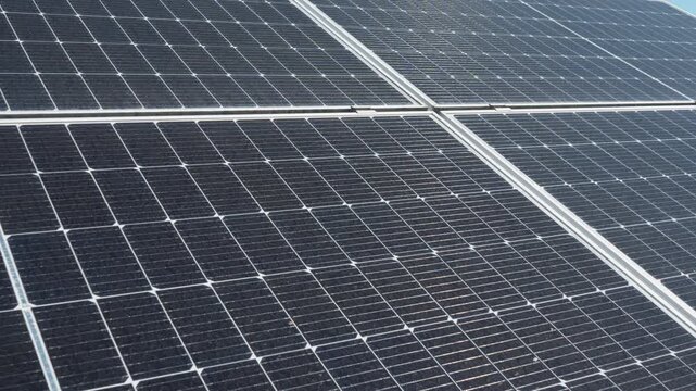 Bifacial photovoltaic solar panels installed on ground mount racking system. Industrial renewable energy farm with high efficiency modules for sustainable power generation and electricity.