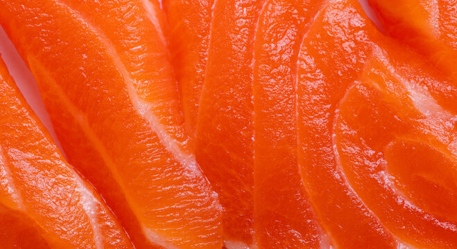 Close-up texture of fresh raw salmon fillet with white fat lines,Macro shot of fresh raw salmon fillet showing detailed texture, vibrant orange color, and natural white marbling fat lines.