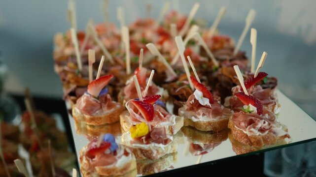Catering service on banquet table with canape snacks in restaurant or hotel. Decorated food set on birthday, wedding celebration or business conference event venue.