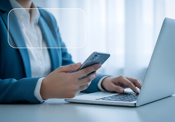 Obraz premium Person in blue suit using smartphone and laptop at desk