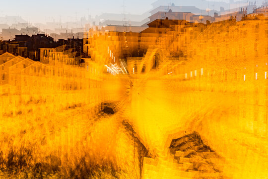 Zoom burst. Blurry photo of city with yellow tone, Sovana, Tuscany, Italy, long exposure motion blur