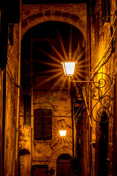Light diffraction view of a street with a light and a building, Sovana, Tuscany, Italy, long exposure motion blur