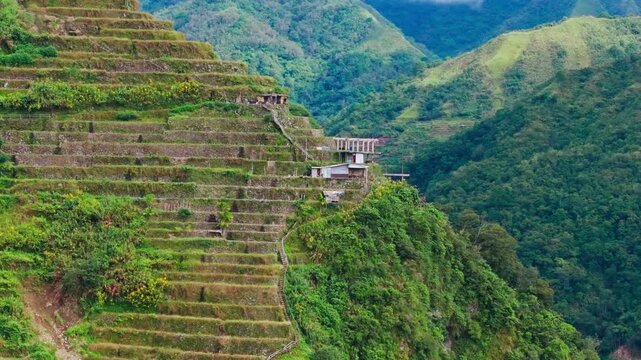 Drone pullback reveals Batad rice terraces and mountain village in Philippines