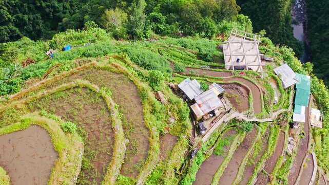 Drone rotates and rises over Batad Rice Terraces Banaue Ifugao Philippines