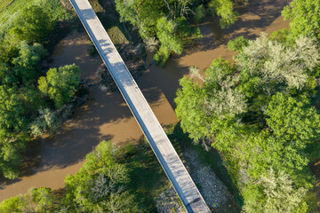 Obraz premium highway and bridge over Bourbeuse River in flooding stage, Missouri Ozarks near Rosebud, aerial view of springtime scenery