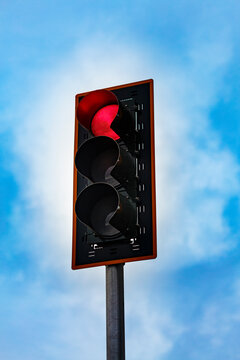 Red stoplight on a pole, a low angle view