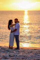 Fototapeta premium Romantic Couple Hugging on the Beach at Sunset, Ocean Background, Golden Hour
