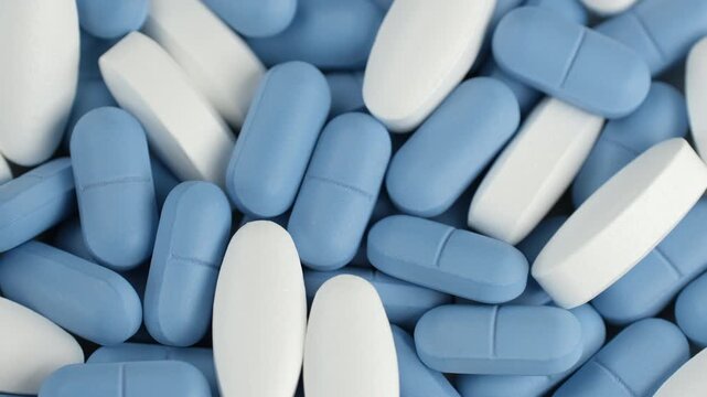 Heap Mixed blue and white pills, slider view. Pharmaceutical Industry concept