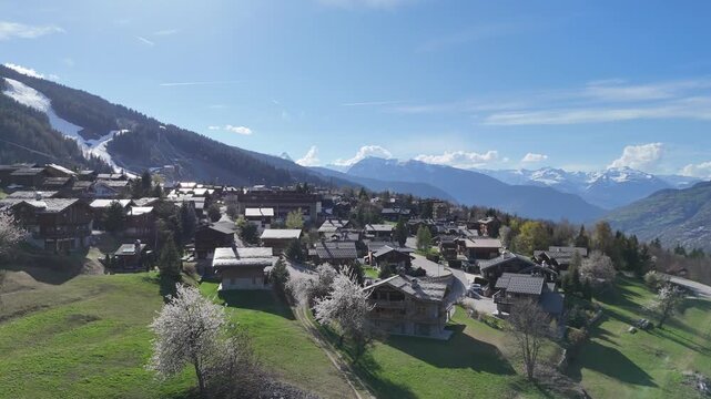 Aerial view of le Praz village in Courchevel ski resort by spring, with chalets and houses in French alps mountains