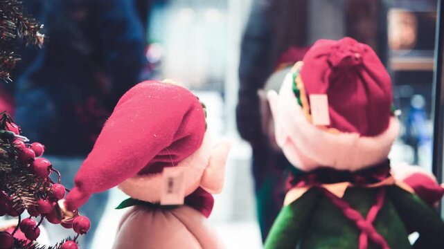 Christmas puppets in a shop showcase with city life outside, slow motion