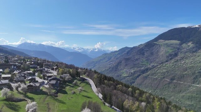 Aerial view of le Praz village in Courchevel ski resort by spring, with chalets and houses in French alps mountains