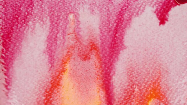 Close up of red watercolour drawing paints on paper. Artist draws with a brush, liquid analog effects for background with copy space for text in center. 