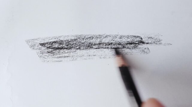 close up of charcoal pencil drawing on textured paper. slow motion footage. Background video can be used as overlay. doodling hatching