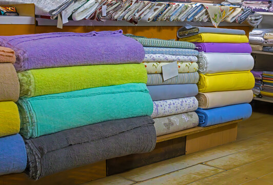 Colorful textile materials on shelf inside local industry shop