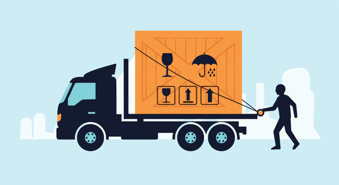 Black flatbed truck transports a large wooden shipping crate with fragile handling symbols while a man pulls it along.