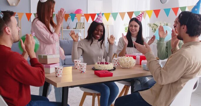 Happy birthday party fun, overjoyed multi ethnic friends group together, smiling diverse people laughing getting birthday surprise gift, cake from friendly, celebrating, enjoying carefree hangout