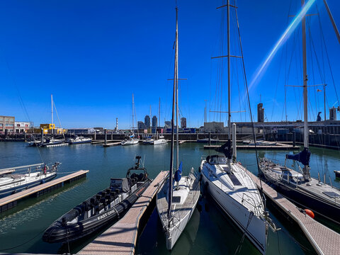 OSTEND, BELGIUM - APRIL 30, 2026: Sailing yachts moored at the marina harbor on a sunny spring day with clear blue sky in Ostend, Belgium.