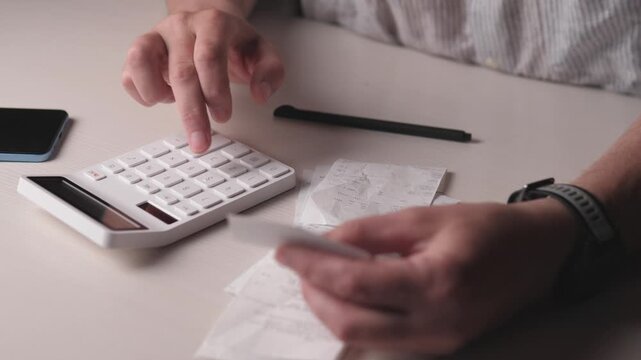 family budget the concept of spending in the store counting on a white calculator at home 4k