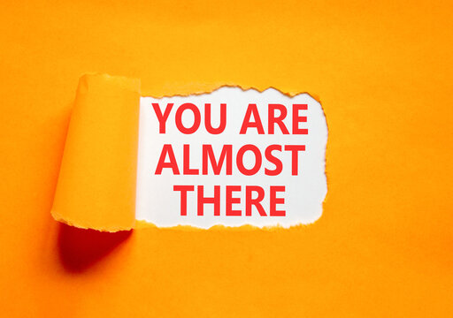 You are almost there words symbol. Concept words You are almost there on beautiful white paper. Beautiful orange background. Business You are almost there motivational support concept. Copy space.