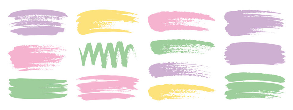 Collection of pastel colored paint brush strokes and scribbles on white background