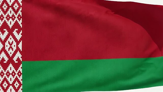 The video captures the national flag of Belarus waving in the wind. The flag features a red and green horizontal design with a traditional red-and-white ornamental pattern on the left side.