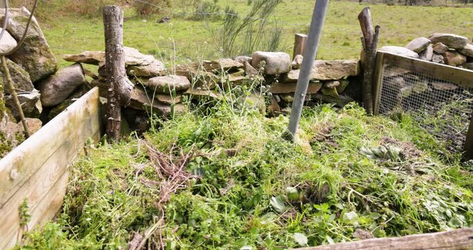 Decomposing organic matter in a rustic compost bin