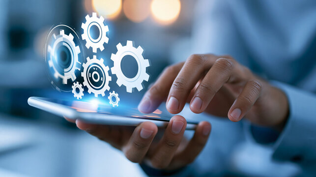 Mobile app development concept showing a faceless person using a phone with gear icons for a tech and innovation design. Defocused background. Mobile app gears, phone development,