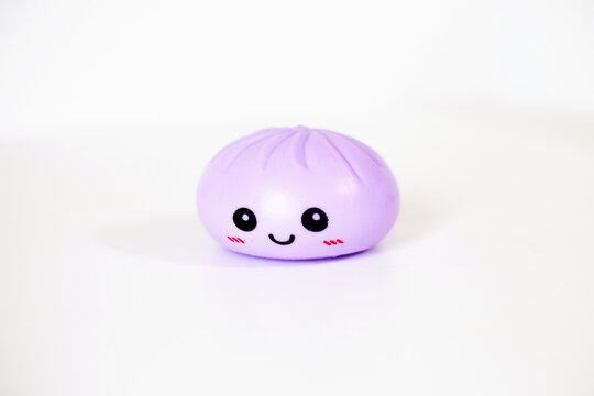 Purple kawaii squishy dumpling antistress toy on white background