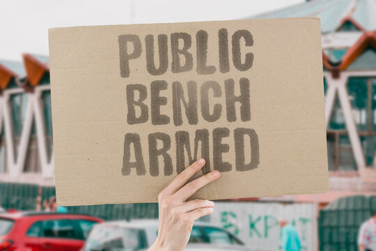 "Public Bench Armed" Hostile urban design uses armrests and dividers to deter homeless rest. HOSTILE. URBAN. ARMRESTS. DIVIDERS. DETER.