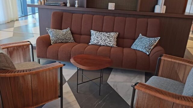 Living room setup with modern couch and chairs in a stylish space