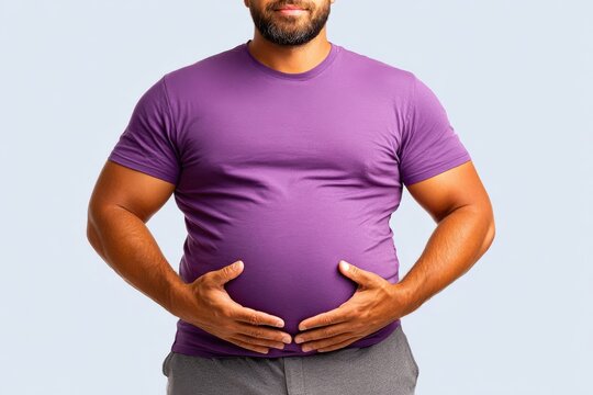 Overweight man holding his belly in purple t-shirt close-up showing body and health concerns