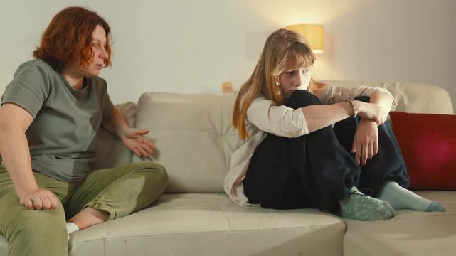 Mother scolding sad teenage daughter during conflict