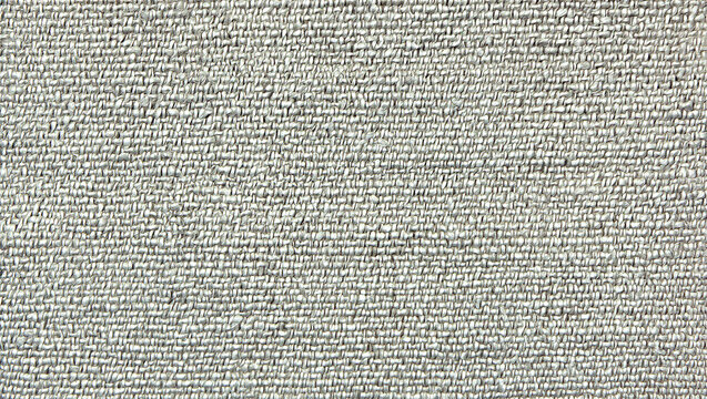Closeup texture of a light gray woven fabric with subtle diagonal patterns and soft shading details