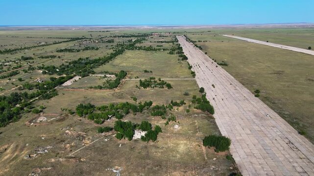 Panoramic drone view of a massive abandoned runway at the Chagan airbase. Located within the Semipalatinsk Nuclear Test Site territory in Kazakhstan. Unique footage of a heavy duty Soviet strategic 