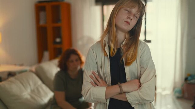 Frustrated teen daughter arguing with mother at home