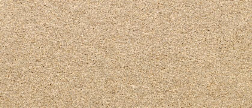 Beige recycled kraft paper texture with natural fiber inclusions for rustic eco friendly background