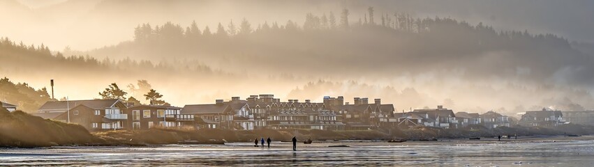 Morning fog in the valleys of the coast mountain range with ocean front homes in forground, Seaside, Oregon © Bob