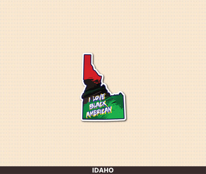 Bold Idaho state shaped sticker featuring Pan-African colors &mdash; red, black and green &mdash; with rough brush texture and "I Love Black American" grunge typography. A proud statement of Black American