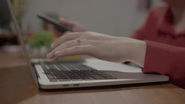 Cybersecurity and two factor authentication concept featuring a businesswoman working on a laptop while verifying login access on a smartphone, illustrating secure digital identity and modern online p