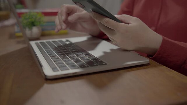 Businesswoman using a laptop and smartphone for two factor authentication login, representing cybersecurity, secure access, and modern digital verification technology.