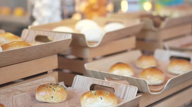 Freshly Baked Bread Rolls in Wooden Crates at Artisan Bakery Display